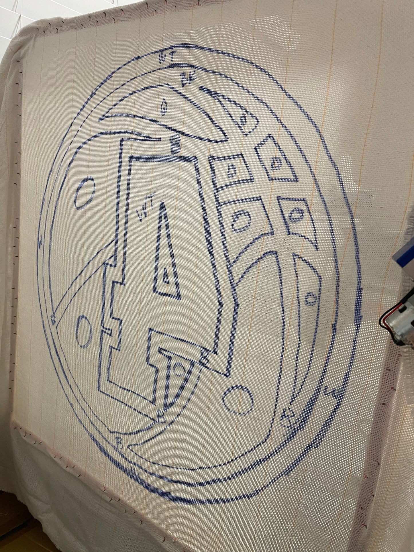 Outline of a number '4' and numbers on a fabric surface.