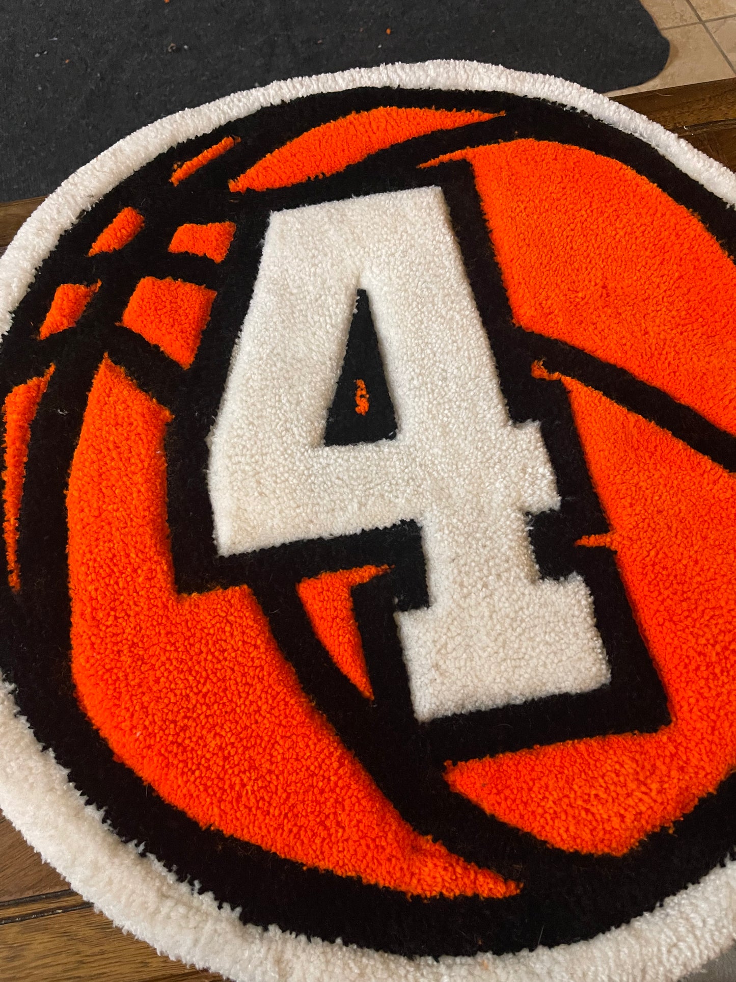 Round basketball rug with a large white number '4'