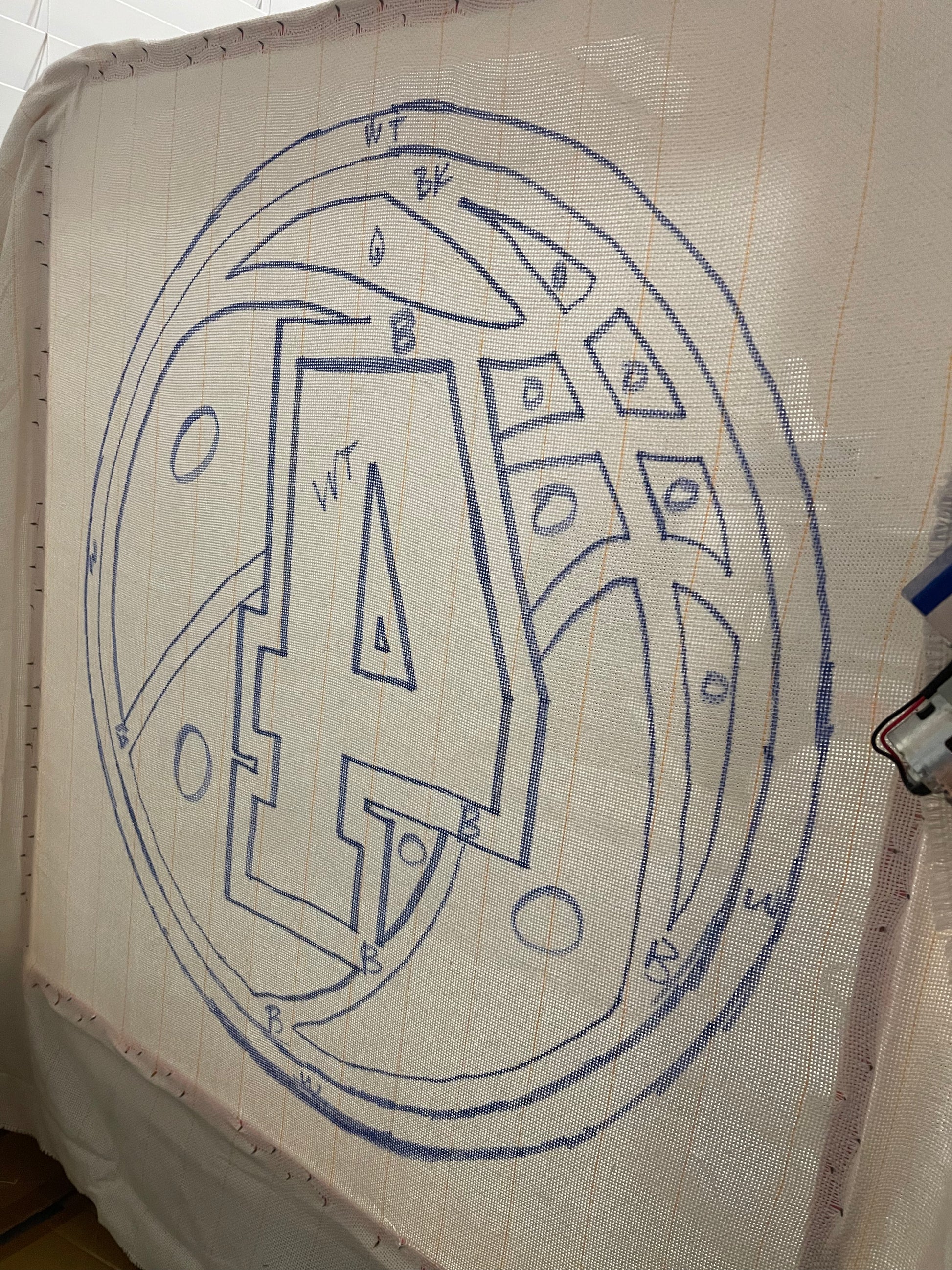 Outline of a number '4' and numbers on a fabric surface.
