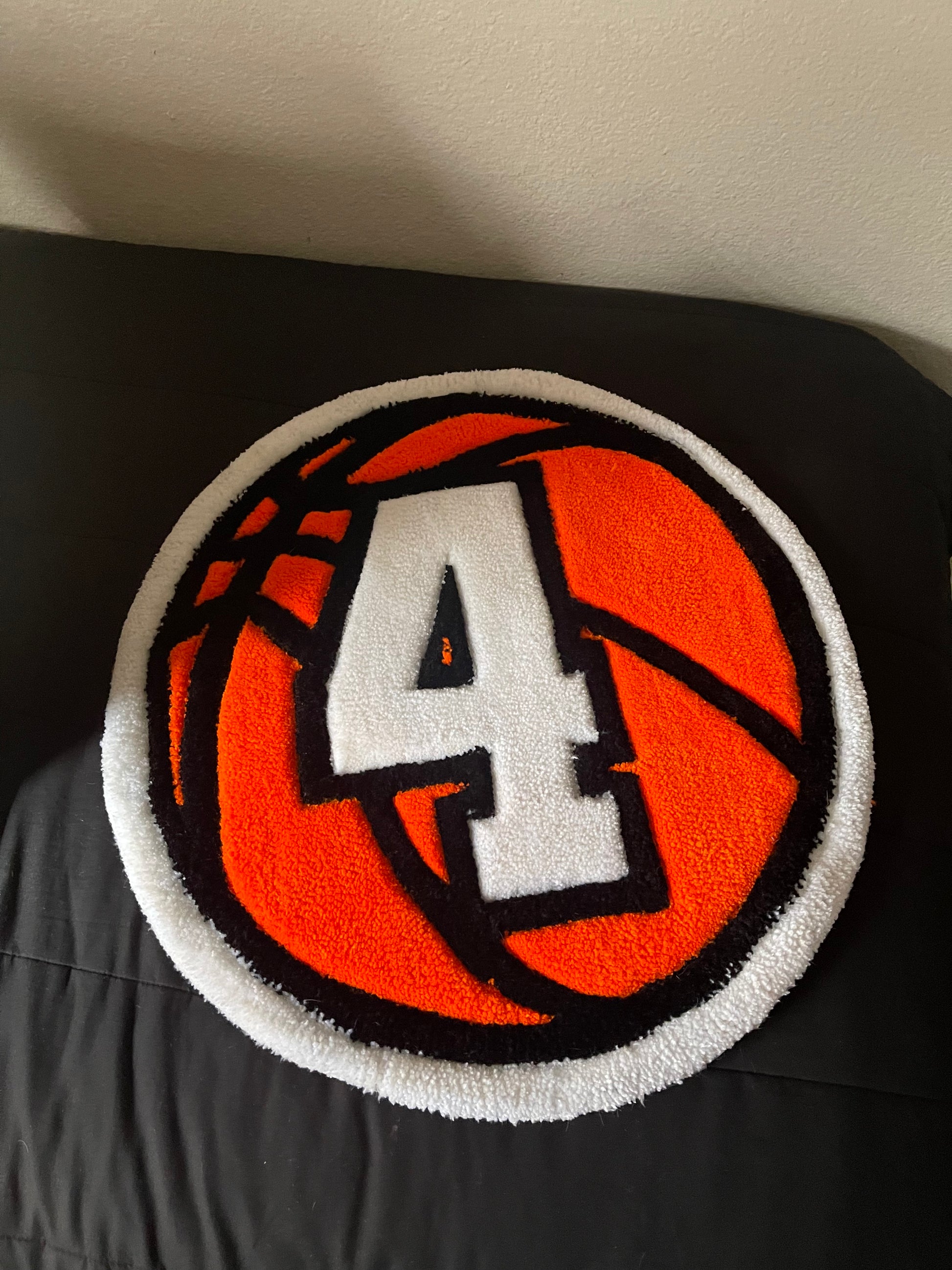 Basketball-themed rug with number 4 on a black background